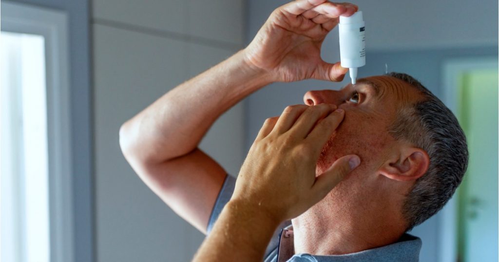 Mature Man Using Eye Drops