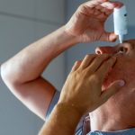 Mature Man Using Eye Drops