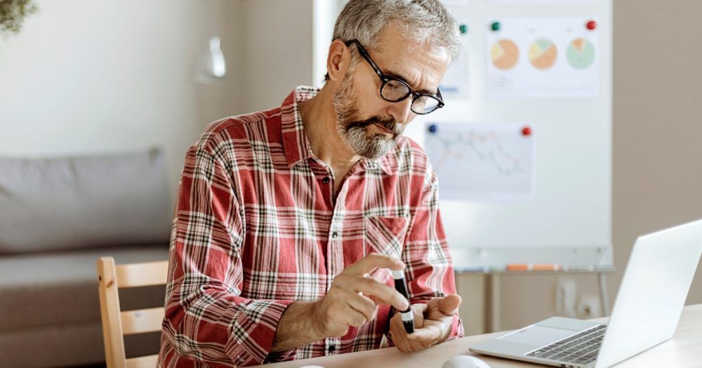 Diabetic Man Taking Blood Test